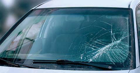 Close-up broken car windshield on the driver side